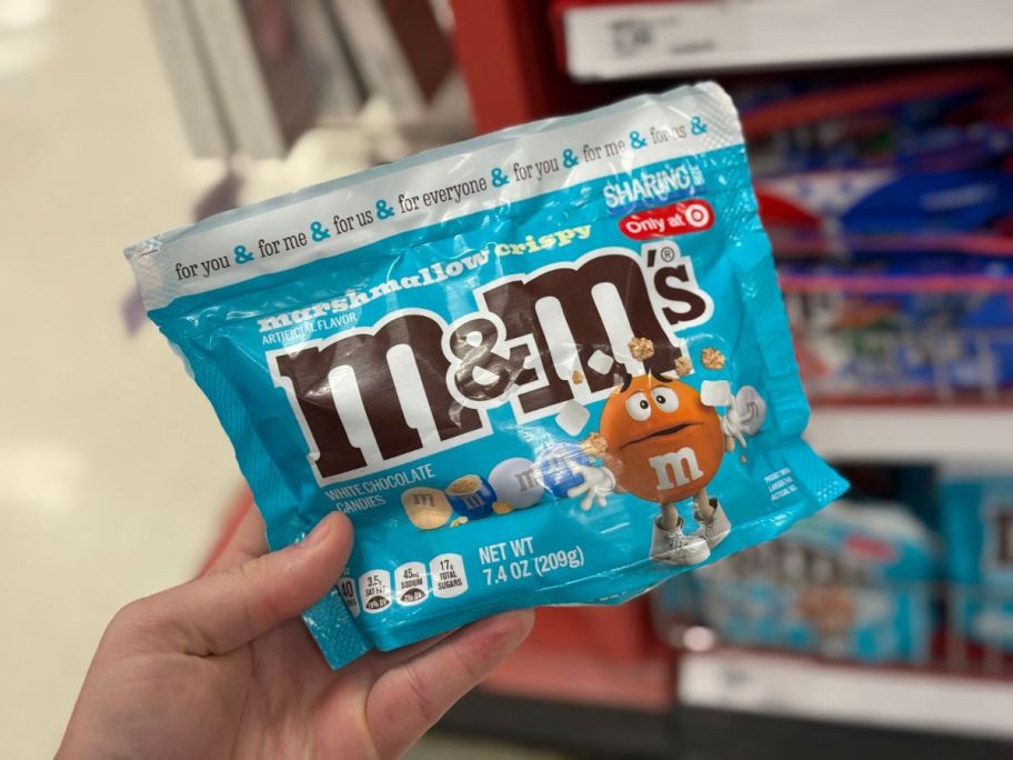 A person holding a bag of Marshmallow Crispy M&M's