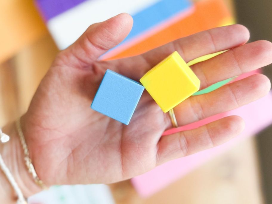 Hand holding two magnetic building blocks