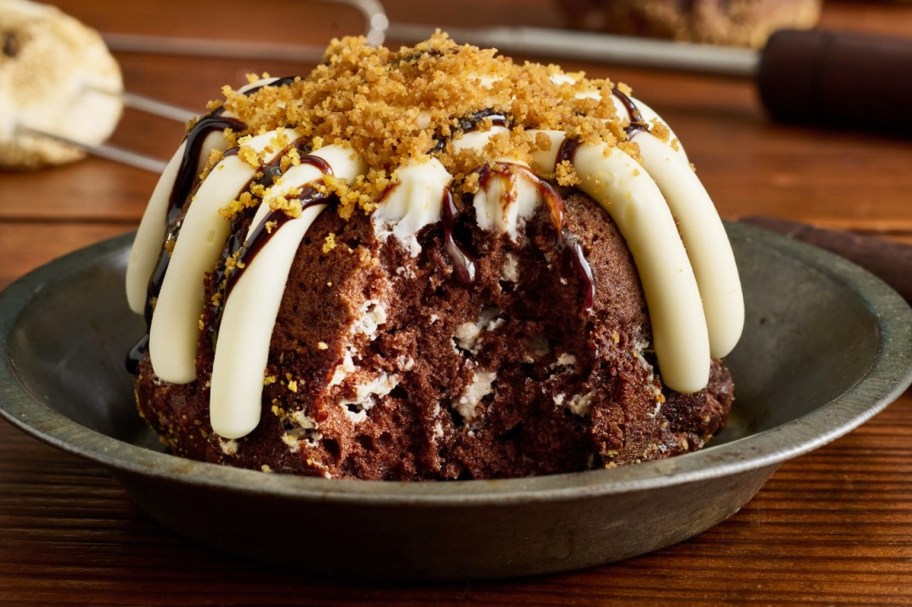 mini chocolate bundt cake with white frosting and graham cracker crumbs