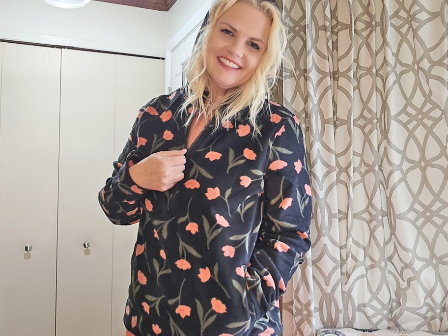 woman wearing a black and pink flower print half-zip hoodie