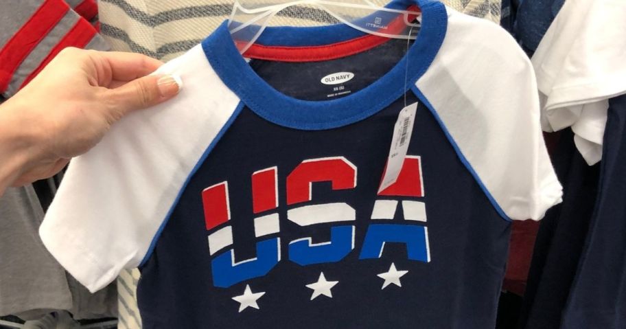 Hand holding an Old Navy USA shirt