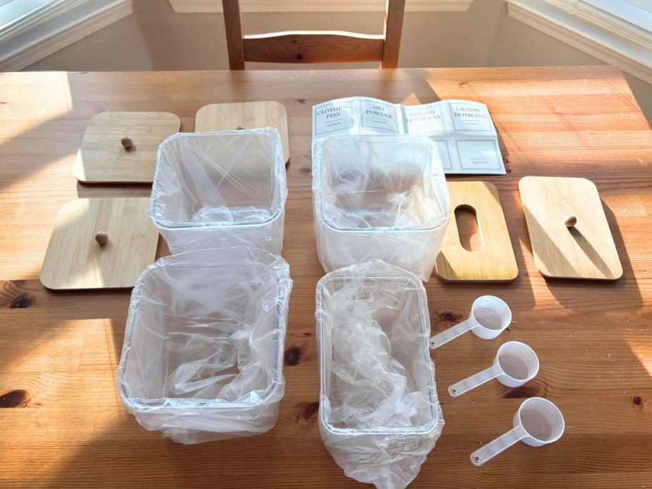 laundry detergent containers with bamboo lids on a table