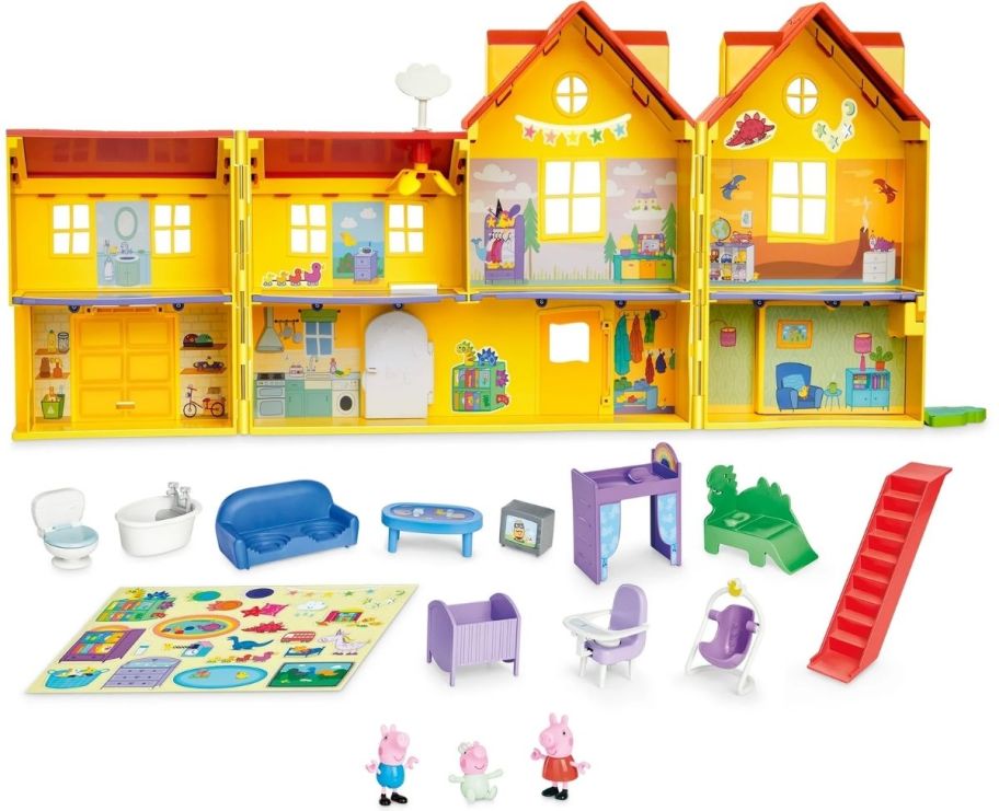 a yellow dollhouse shown with furniture, dolls and accessories