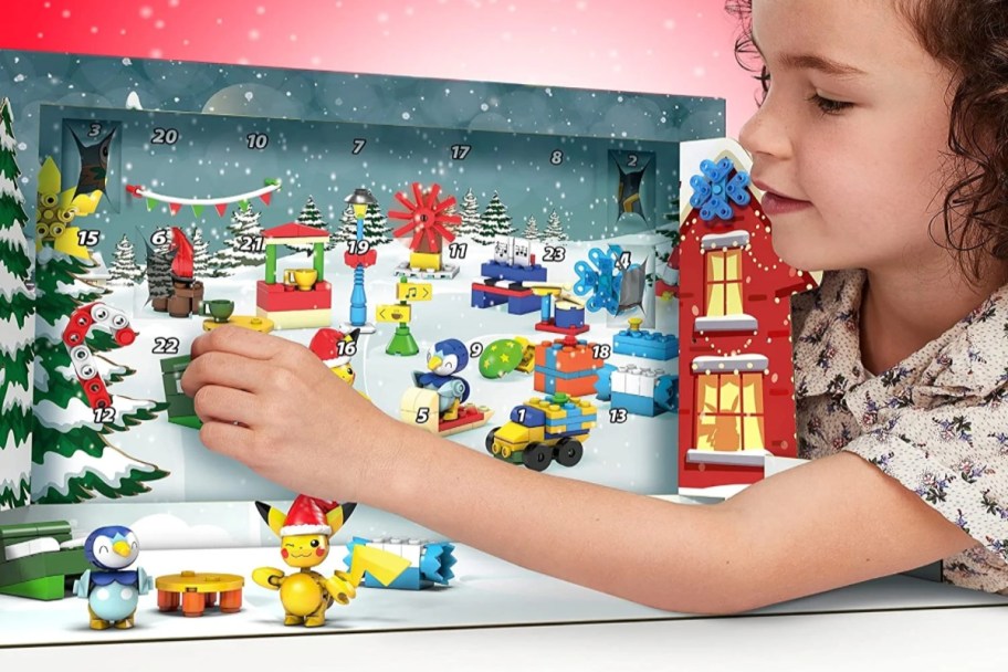 Child playing with Pokemon Advent Calendar. Opening the doors.