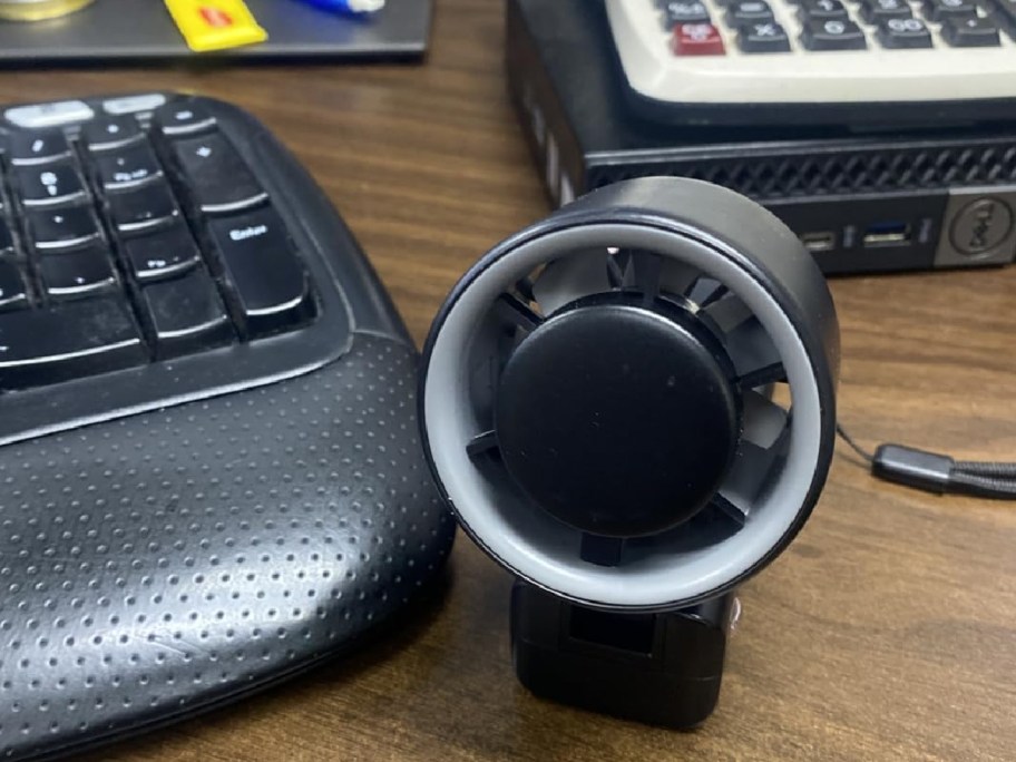 portable fan displayed on a desk next to a keyboard