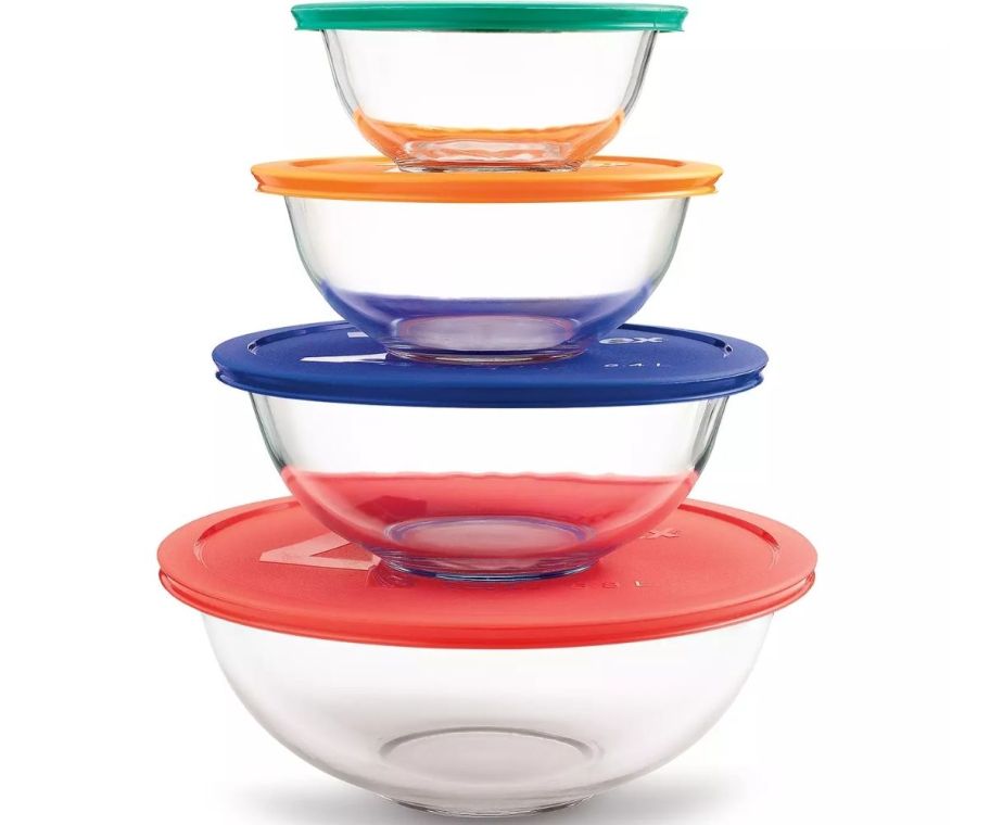 a stack of 4 round glass food storage bowls with color coded lids