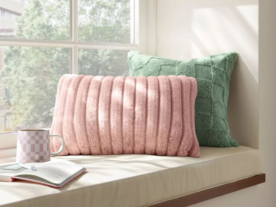 Room Essentials Channeled Faux Fur Lumbar Throw Pillow on a window seat