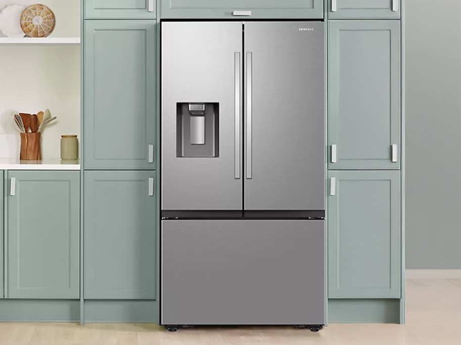 Samsung 31 cu. ft. French Door Refrigerator in a kitchen with cabinets