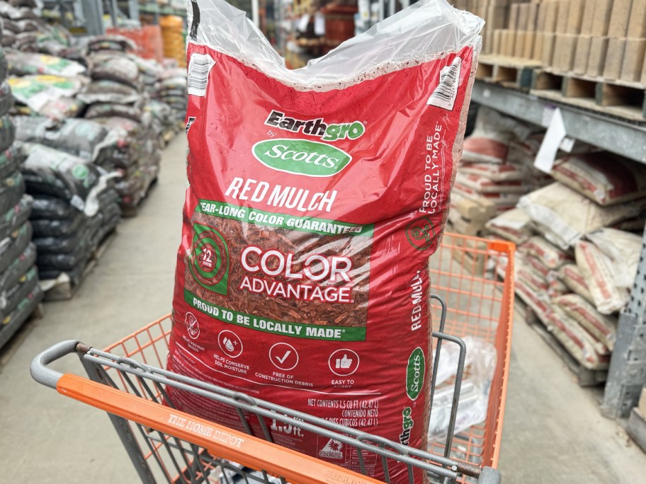 red bag of Scott's Earthgro Mulch in Home Depot shopping cart
