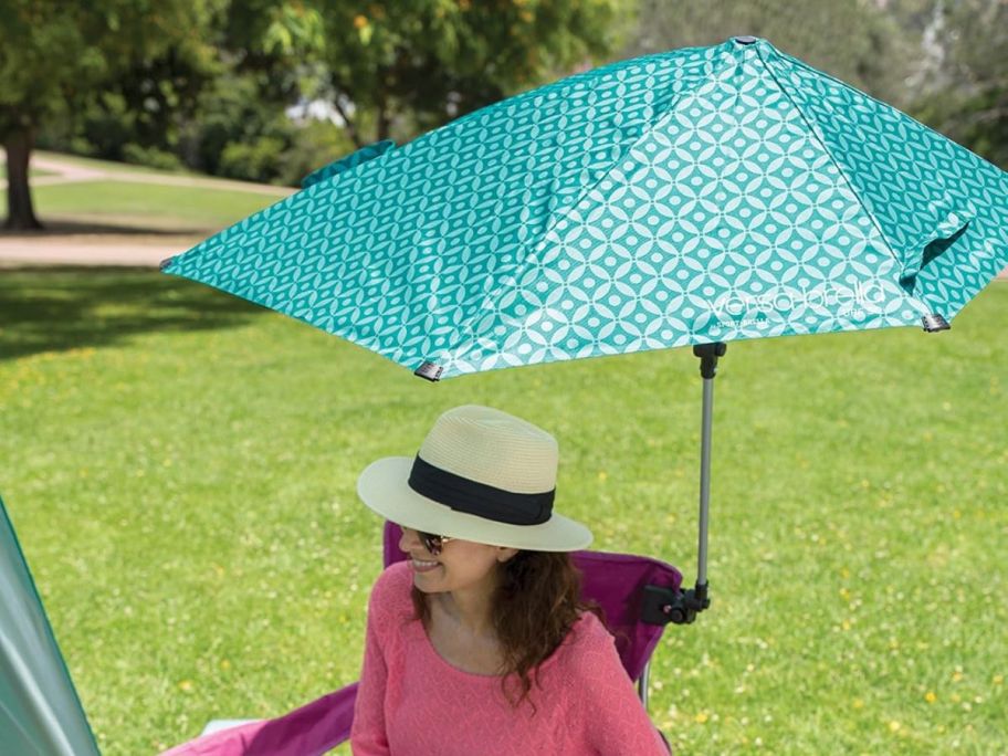A woman with an umbrella attached to her chair 
