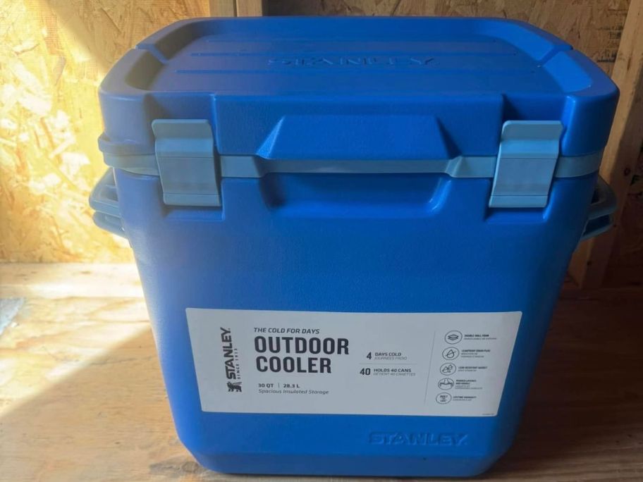 A blue Stanley cooler in an attic