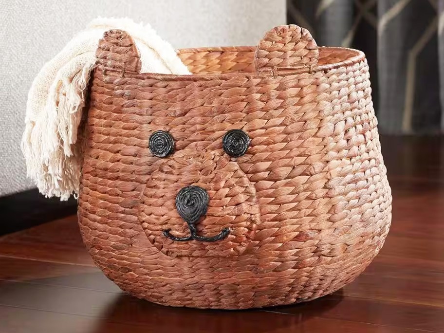 brown teddy bear shaped basket with blanket inside