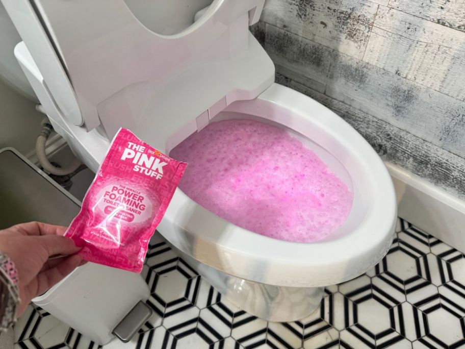 A toilet with The Pink Stuff Foaming Toilet Cleaner inside the bowl