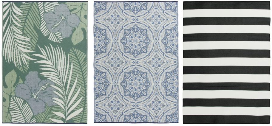 Three Walmart outdoor rugs shown side by side: a green tropical leaf and hibiscus print, a blue and white medallion design, and a bold black and white stripe pattern.