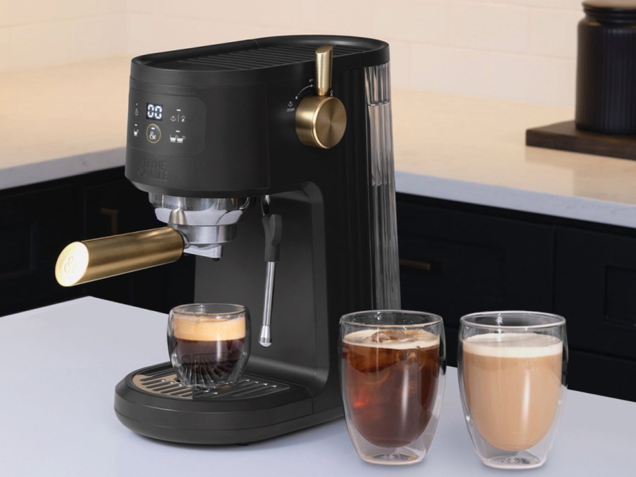 Thyme and table Espresso machine with all the bells and whistles next to three coffee cups filled