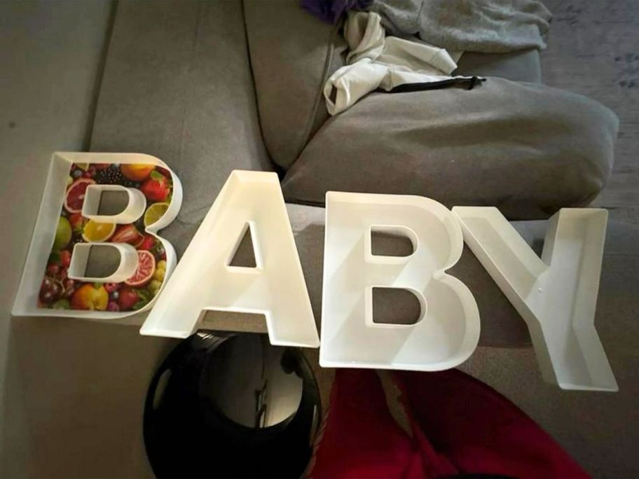 white plastic boxes in the shape of a letters that spell BABY