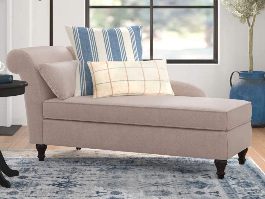 Three Posts Rhoda Upholstered Chaise Lounge with two throw pillows on it