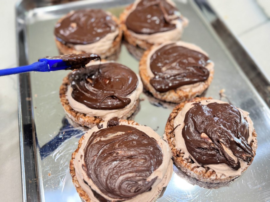 adding melted chocolate to rice cake protein s'mores