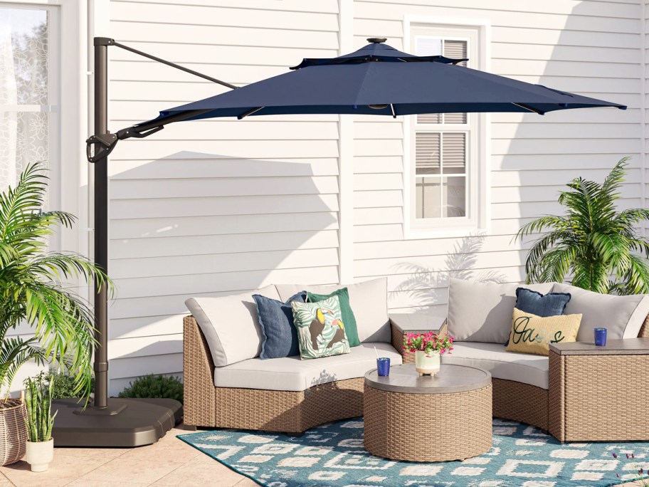 navy blue cantilever umbrella hanging over a patio set