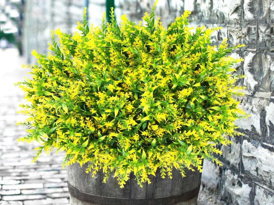 Artificial Yellow Flowers in pot on sidewalk