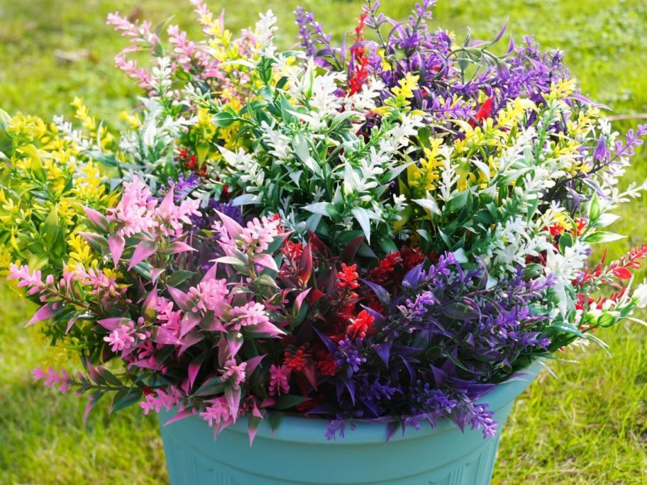 Artificial Mixed Flowers in pot outside on grass