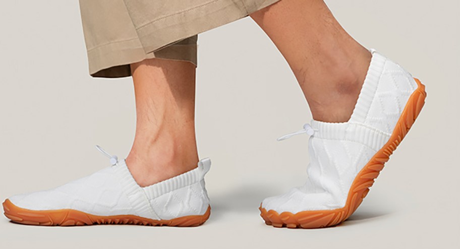 person walking while wearing water shoes