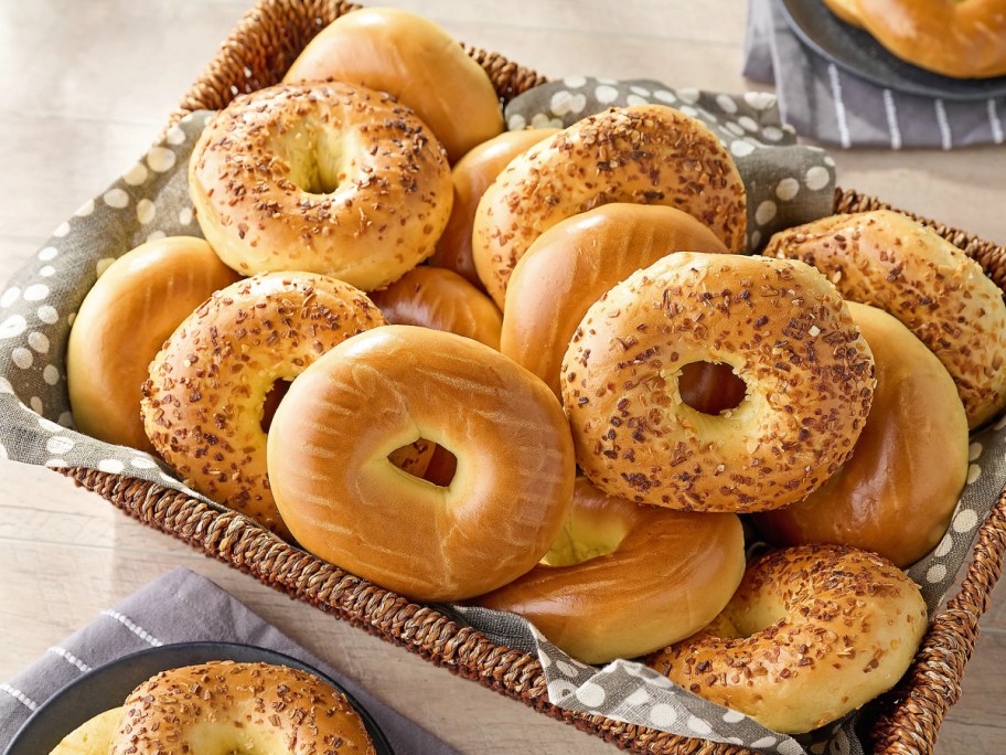 tray filled with different flavor bagels displayed on top of a table