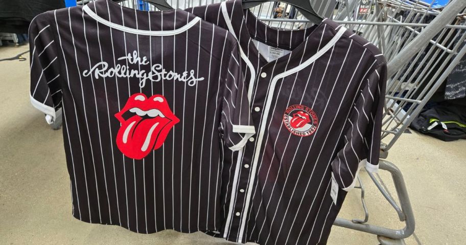 black and white striped Rolling Stones Men's Graphic Baseball Jersey hanging on cart in store