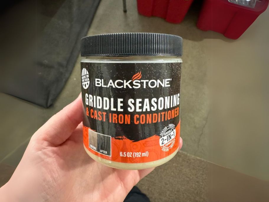 Blackstone Griddle Seasoning & Cast Iron Conditioner jar in hand