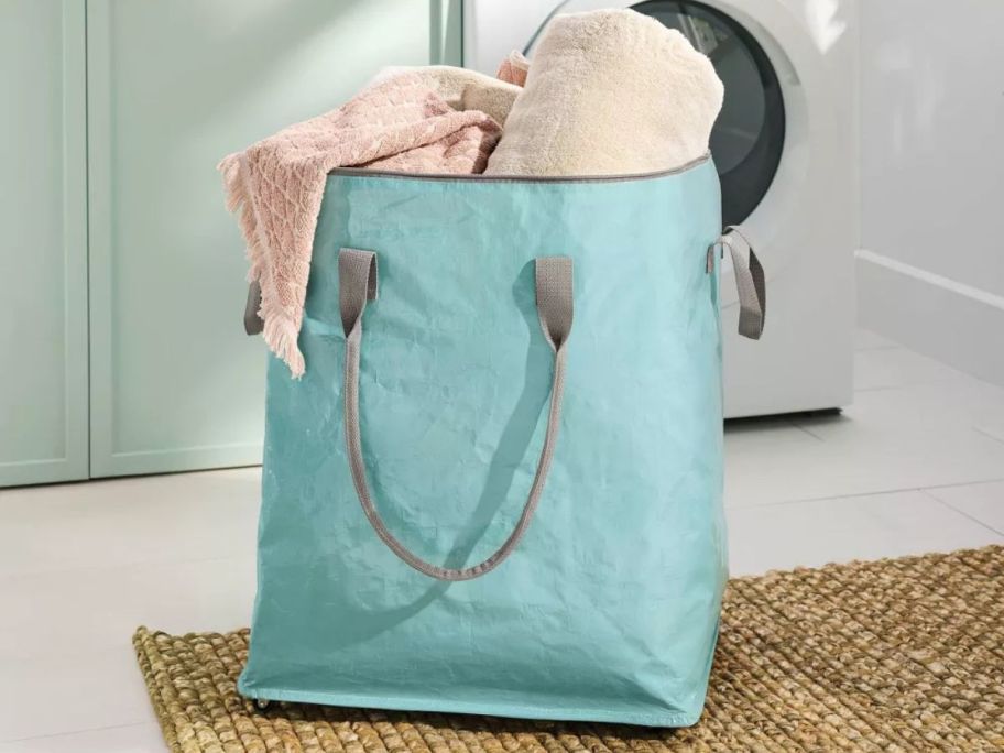 aqua laundry tote filled with blankets