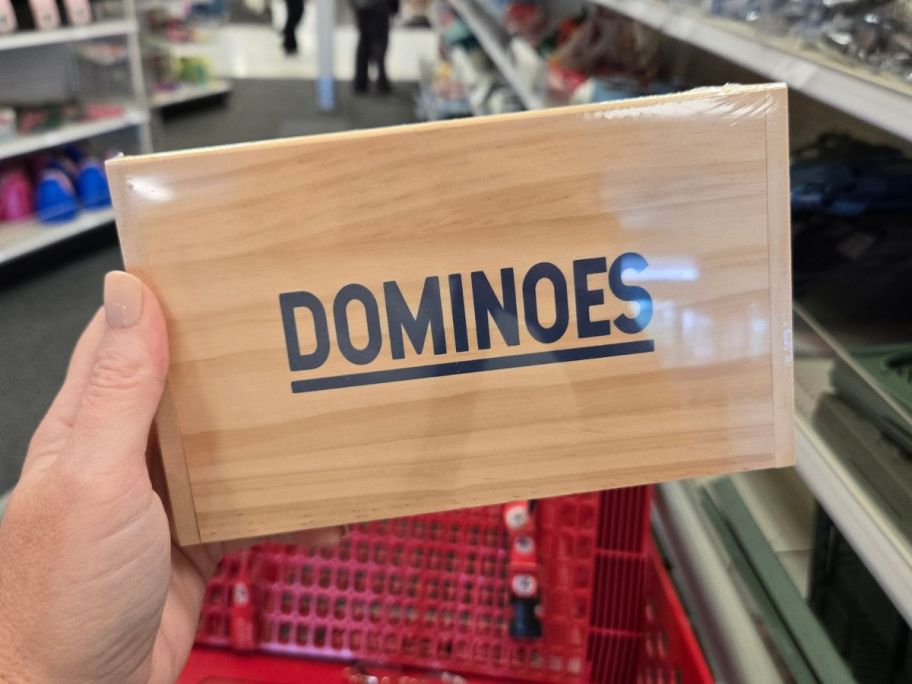 Dominoes box in hand in store