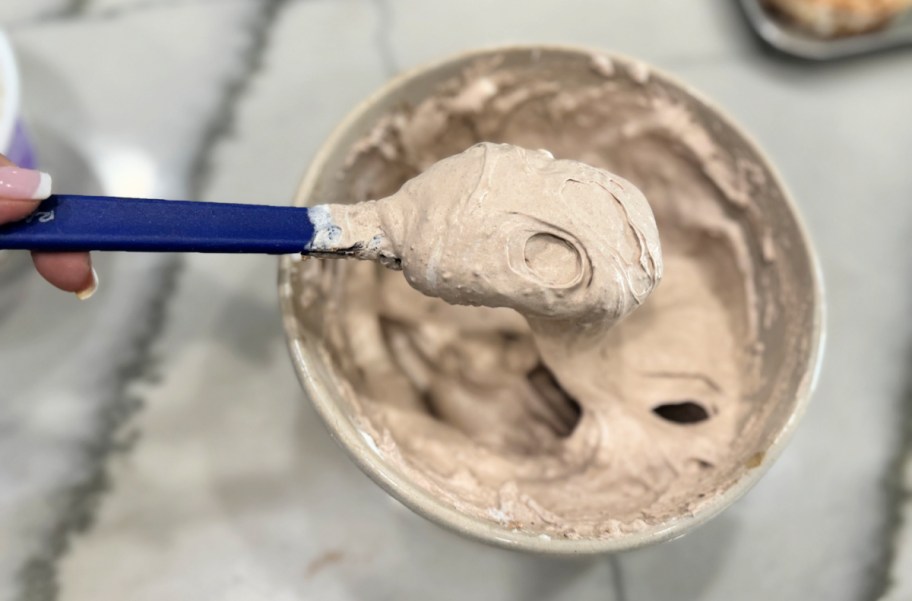 cool whip and protein powder mixed together on a spoon