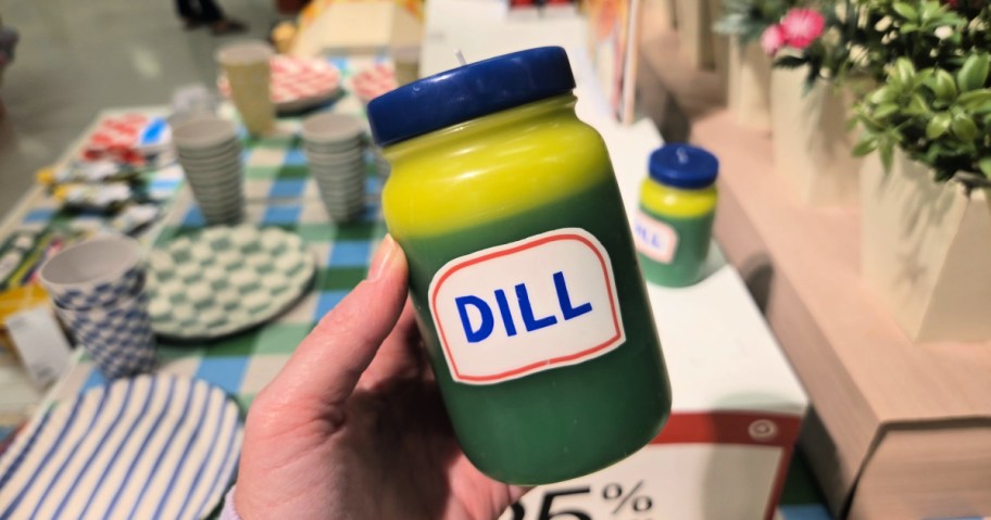 woman holding a dill candle inside target store