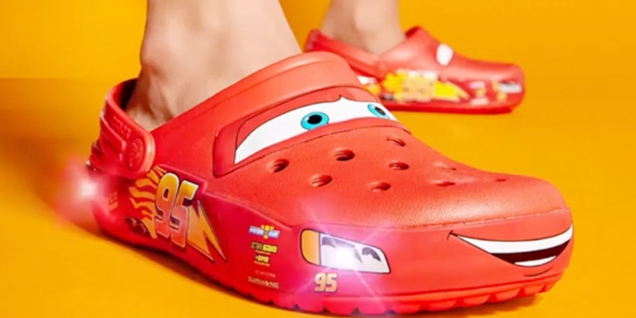 person wearing red cars crocs