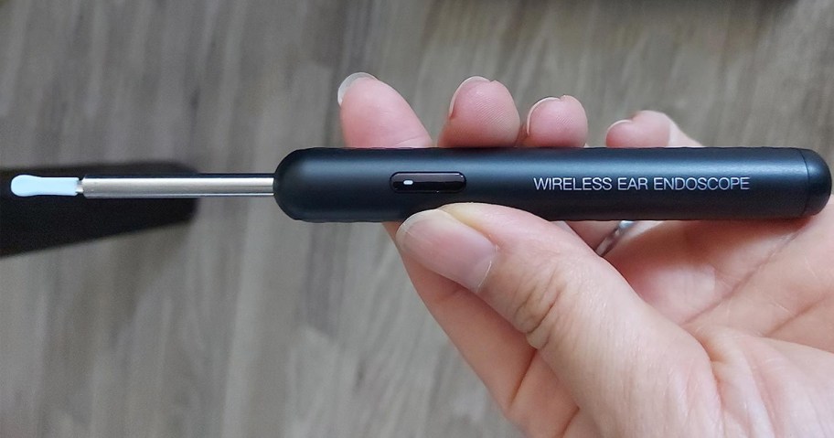 person holding ear wax camera remover