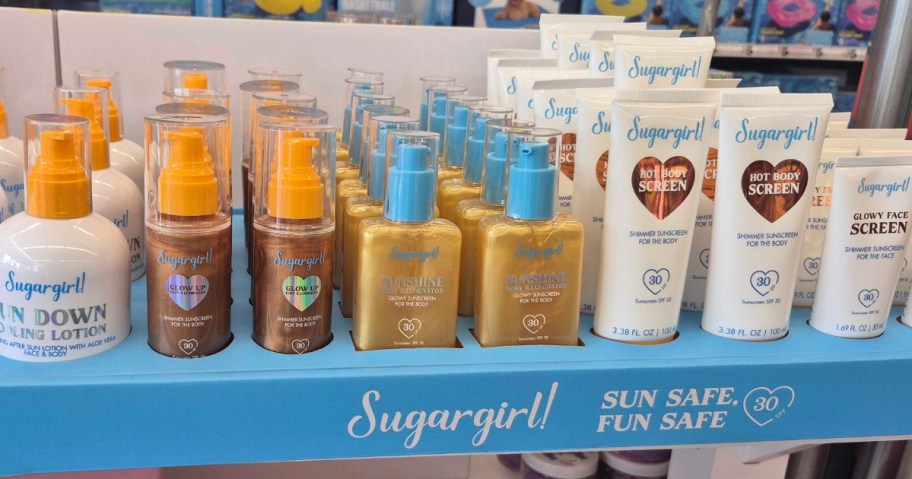 a row of Sugargirl! brand skincare and sunscreen containers on display in a store