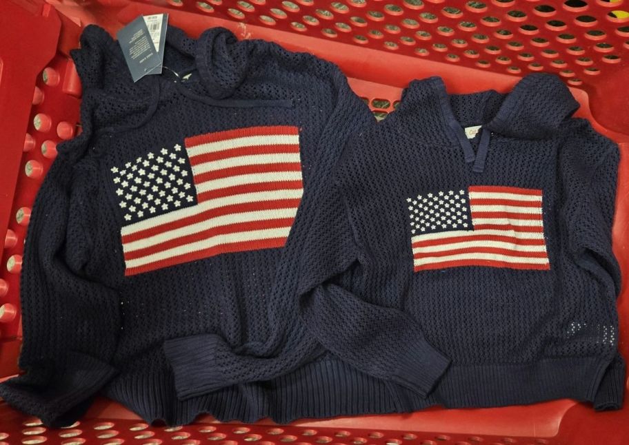 two navy blue hooded flag openwork sweat shirts in a red shopping cart