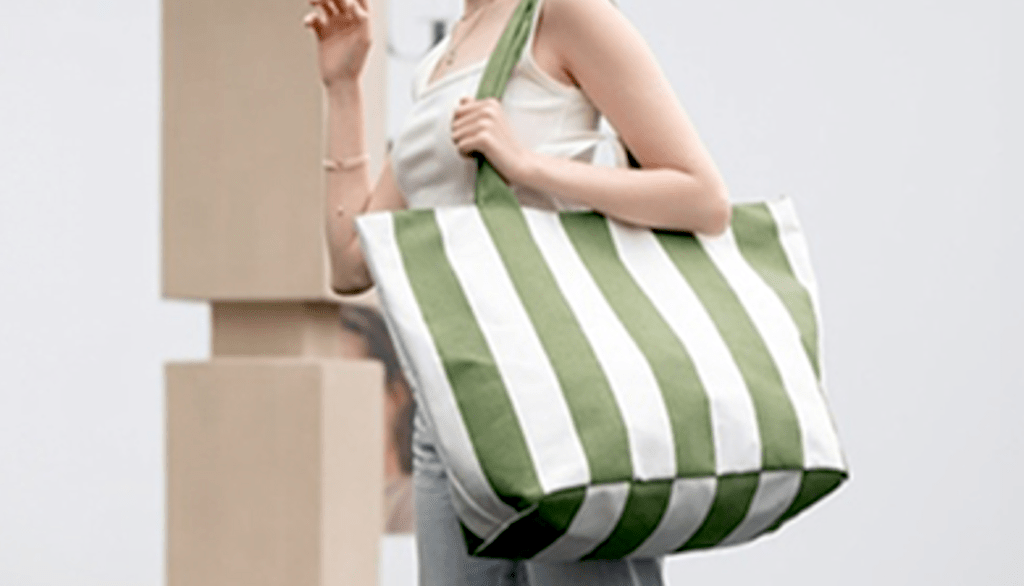 woman carrying striped bag 