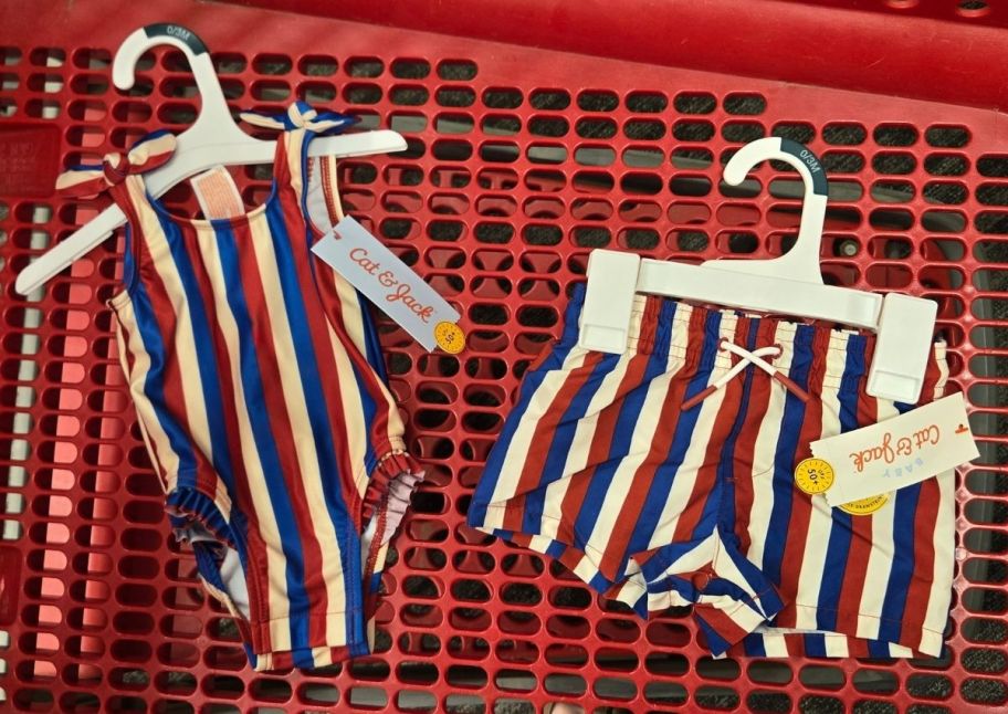 kids red white and blue striped swimsuits in a red shopping cart