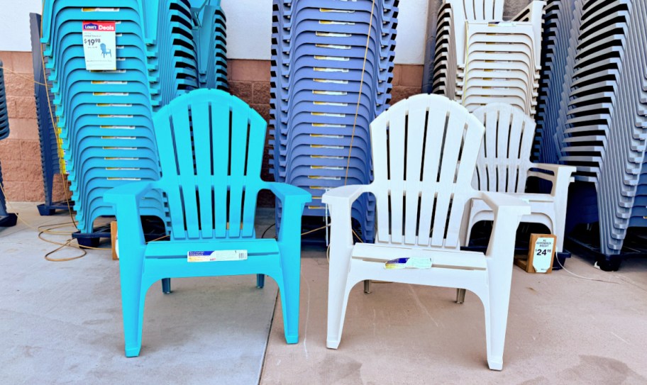 two adirondack chairs next to each other with more stacked behind them