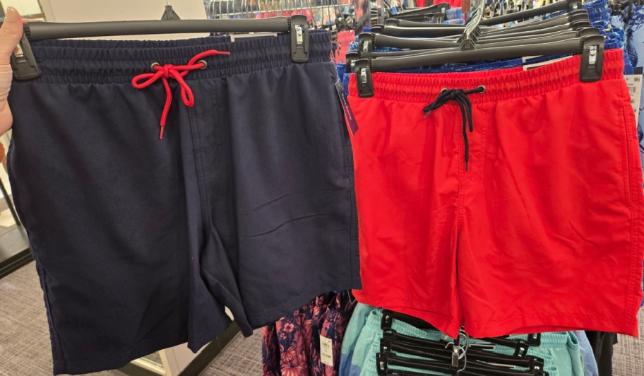 navy and red shorts on hangers in store