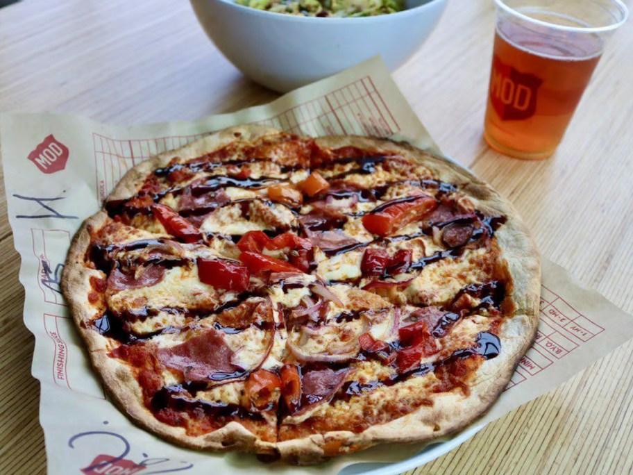 mod pizza on table with drink