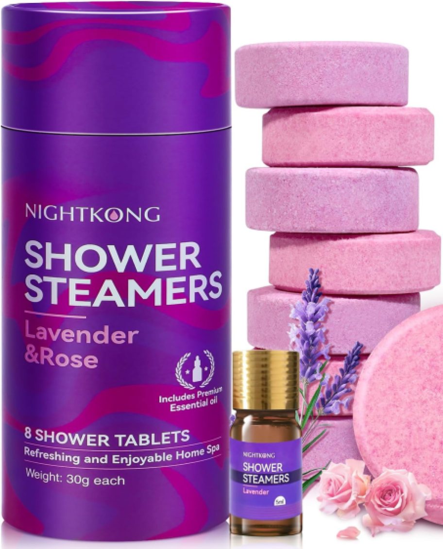 a purple container of shower steamers with a bottle of essential oil