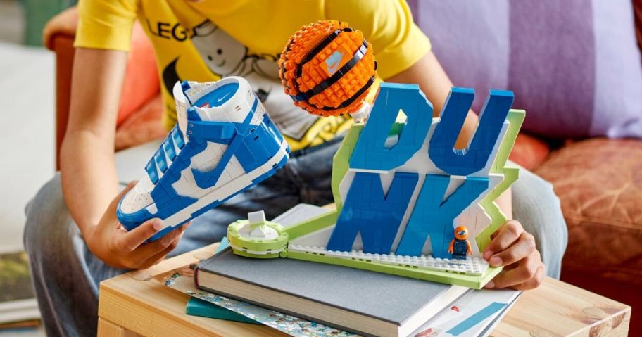 kid holding Nike Dunk x LEGO Set