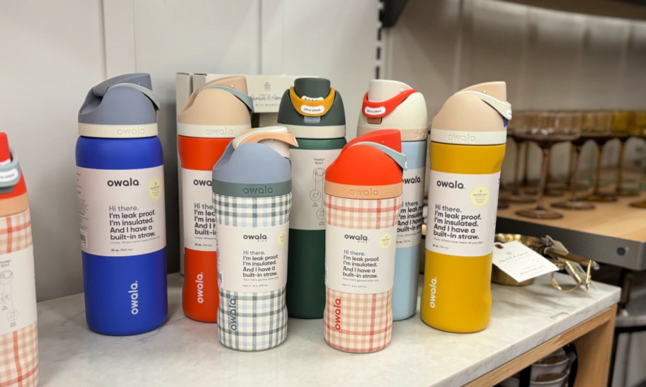 collection of hearth and hand with magnolia owala water bottles in earth tones and gingham prints on a store shelf