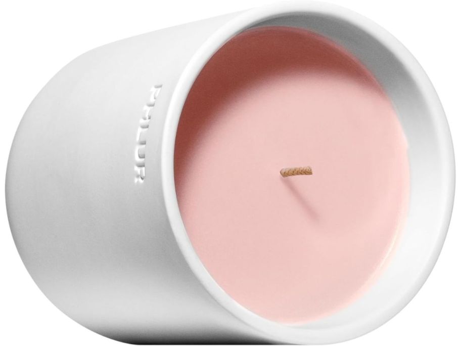 PHLUR Not Your Baby Scented Candle laying in its side