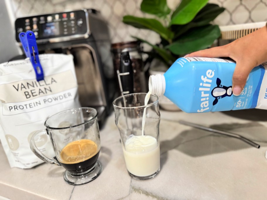 pouring fairlife milk into a cup