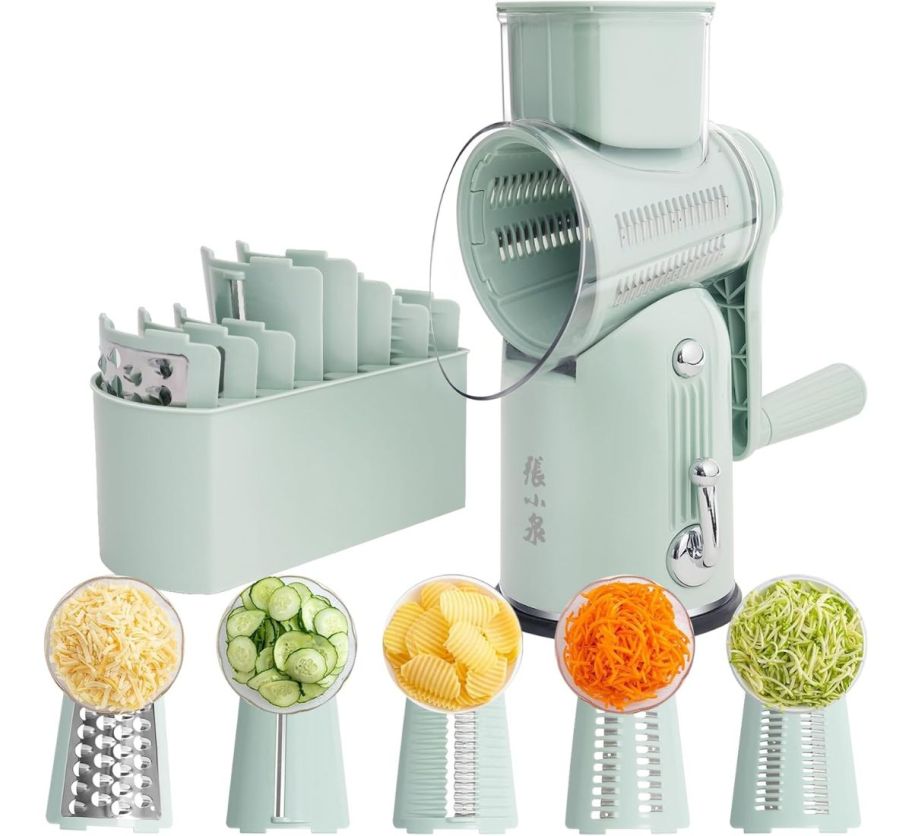 a light green rotary grater shown with extra blades