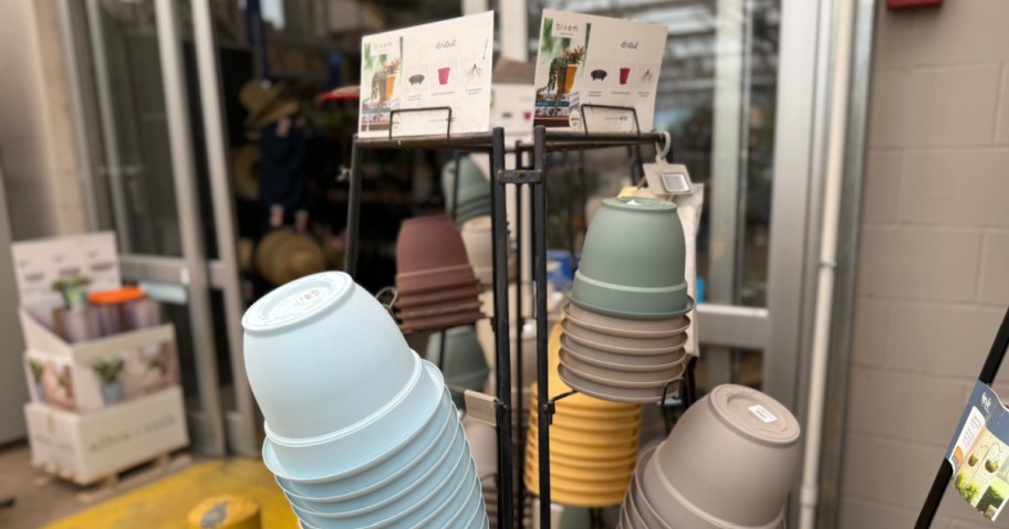 collection of self watering plastic planters on display in a store