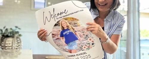 woman holding graduation poster